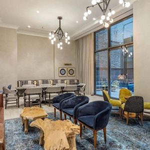 Lounge in the lobby of The Draper, Ascend Hotel Collection, with sofas, comfy chairs, and tables.