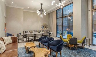 Lounge in the lobby of The Draper, Ascend Hotel Collection, with sofas, comfy chairs, and tables.