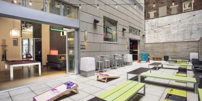 The hotel’s patio area, with plentiful seating and tall stools/tables.