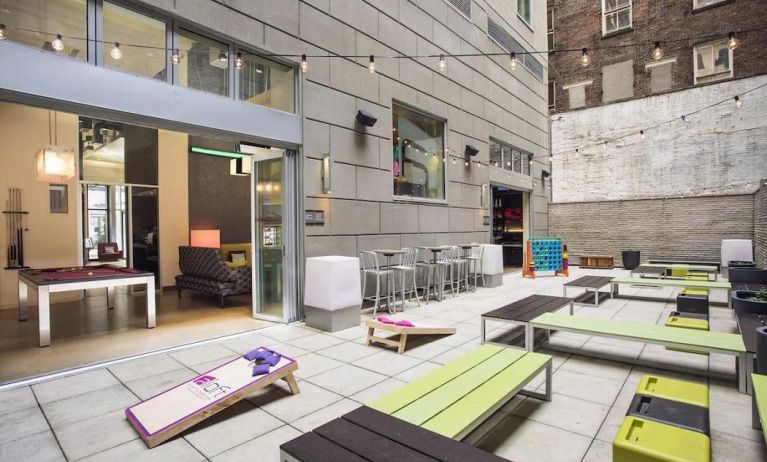 The hotel’s patio area, with plentiful seating and tall stools/tables.