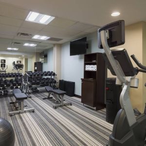 The hotel fitness center, with benches, weights, and various exercise machines.