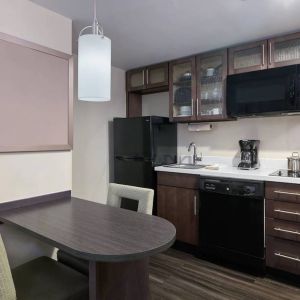 The kitchenette area in a guest room of Candlewood Suites Times Square, including fridge, oven, and microwave.