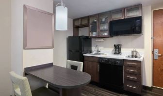 The kitchenette area in a guest room of Candlewood Suites Times Square, including fridge, oven, and microwave.