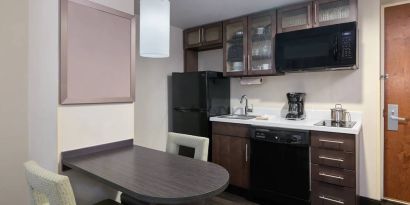 The kitchenette area in a guest room of Candlewood Suites Times Square, including fridge, oven, and microwave.