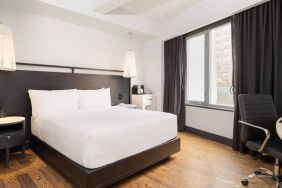 Guest room in the Hyatt Union Square New York, with large bed, window, and workspace.