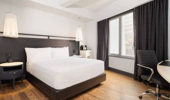 Guest room in the Hyatt Union Square New York, with large bed, window, and workspace.