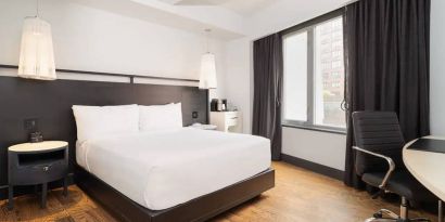 Guest room in the Hyatt Union Square New York, with large bed, window, and workspace.