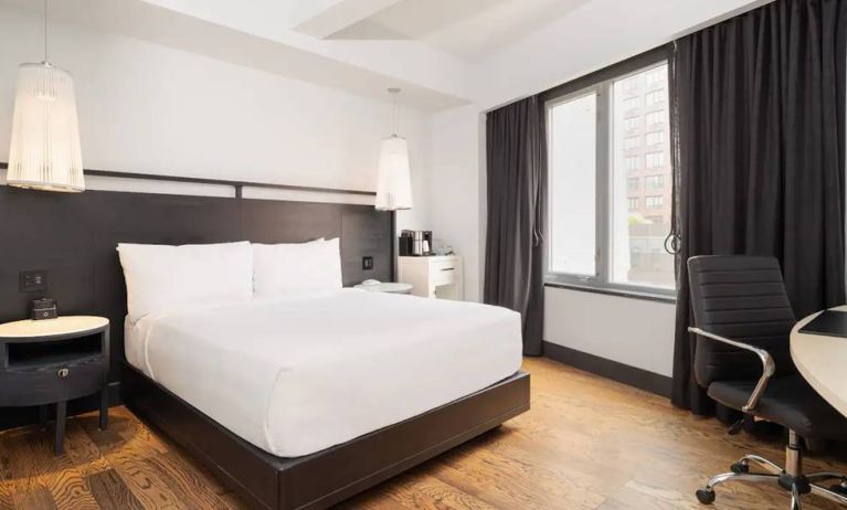 Guest room in the Hyatt Union Square New York, with large bed, window, and workspace.