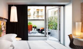 King bed terrace room in the Hyatt Union Square New York, with outdoor lounge area.