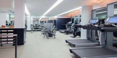 The hotel fitness center, featuring a variety of exercise equipment.