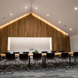 A conference room in the Hyatt Union Square New York with space for over a dozen attendees around a long table.