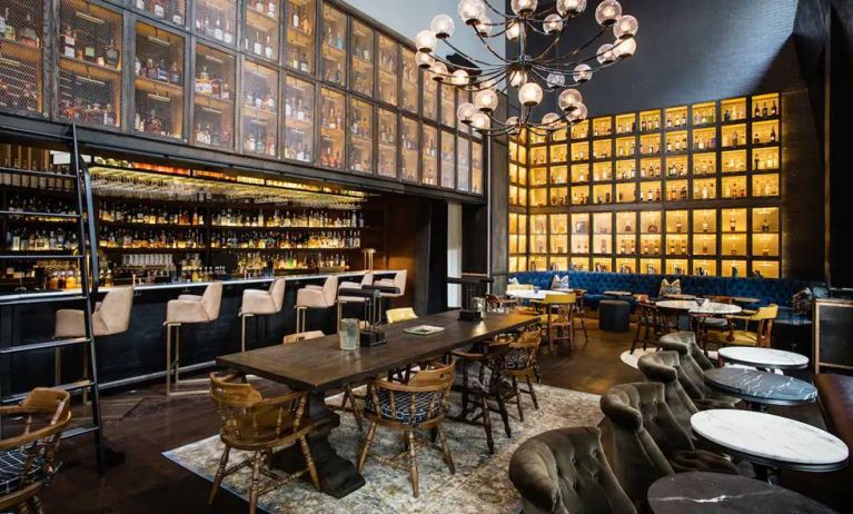 The bar and lounge of Hyatt Union Square New York, with hard floor, bar stools, and range of table sizes.