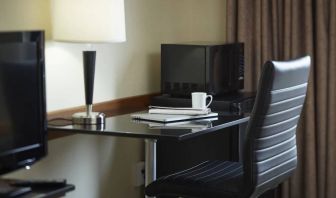 An in-room workspace at the Comfort Inn Belleville, including desk, chair, and lamp.