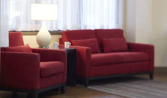 The hotel lobby lounge has comfortable seating and is brightly lit.