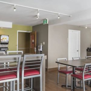 The hotel breakfast area has tall and standard chairs, and a wide range of breakfast fare.