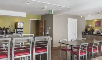 The hotel breakfast area has tall and standard chairs, and a wide range of breakfast fare.