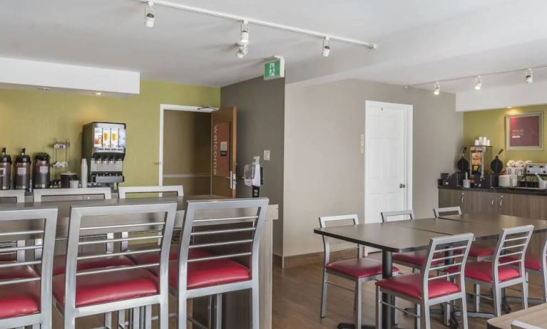 The hotel breakfast area has tall and standard chairs, and a wide range of breakfast fare.