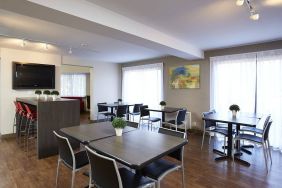 The hotel’s dining area has a hard floor, and is well-lit due to large windows.