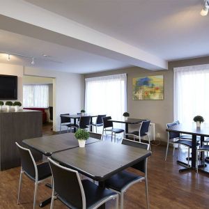 The hotel’s dining area has a hard floor, and is well-lit due to large windows.