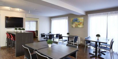 The hotel’s dining area has a hard floor, and is well-lit due to large windows.