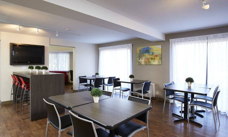 The hotel’s dining area has a hard floor, and is well-lit due to large windows.