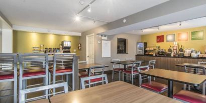 The hotel’s breakfast dining area has a range of table sizes and both standard and tall chairs.