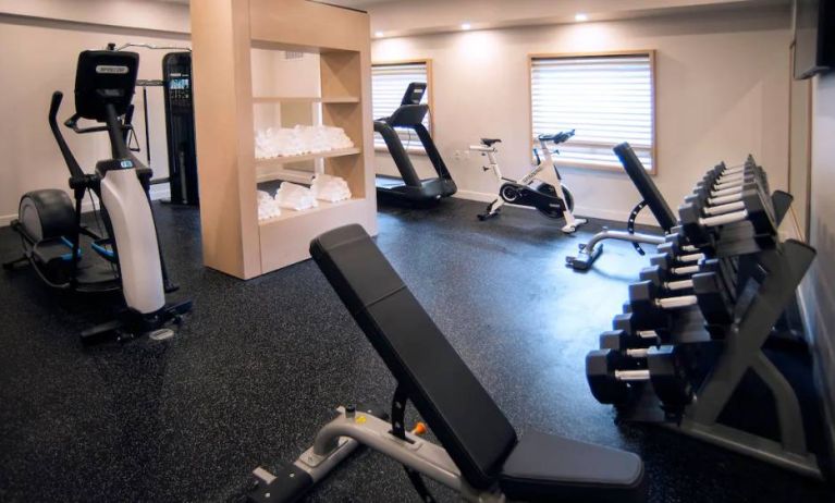 The hotel’s fitness center features racks of weights and exercise equipment.