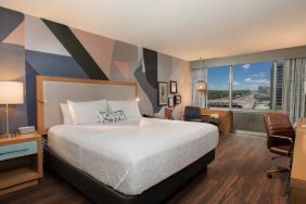 Guest room in The Beeman Hotel, with workspace desk and chair, plus large double bed.