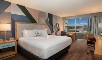 Guest room in The Beeman Hotel, with workspace desk and chair, plus large double bed.