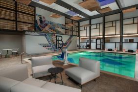 The Beeman Hotel’s indoor pool has seating and tables nearby.