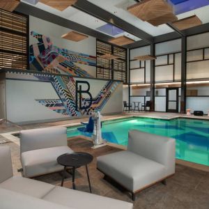 The Beeman Hotel’s indoor pool has seating and tables nearby.