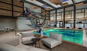 The Beeman Hotel’s indoor pool has seating and tables nearby.