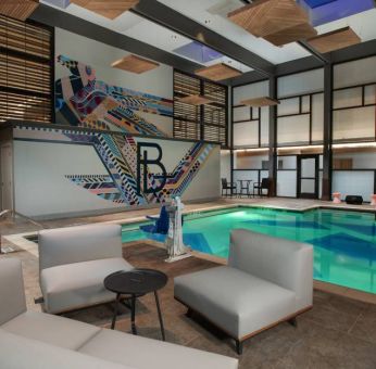 The Beeman Hotel’s indoor pool has seating and tables nearby.