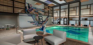 The Beeman Hotel’s indoor pool has seating and tables nearby.