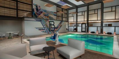 The Beeman Hotel’s indoor pool has seating and tables nearby.