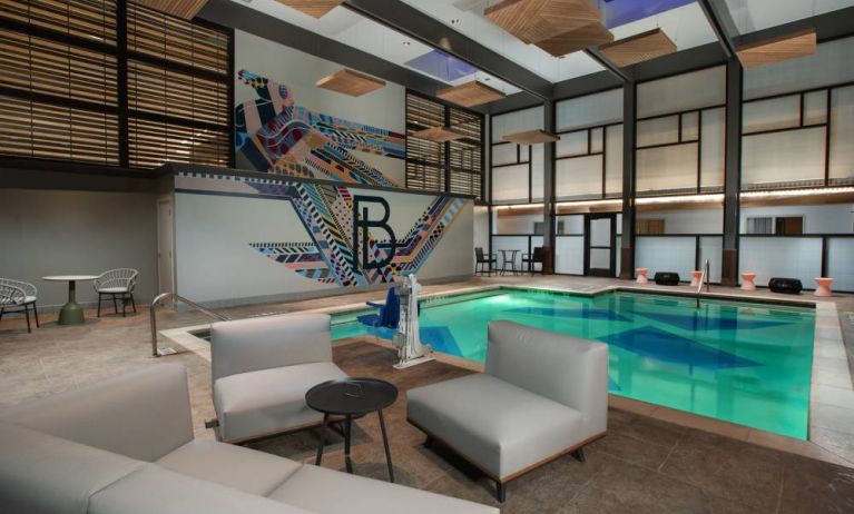 The Beeman Hotel’s indoor pool has seating and tables nearby.