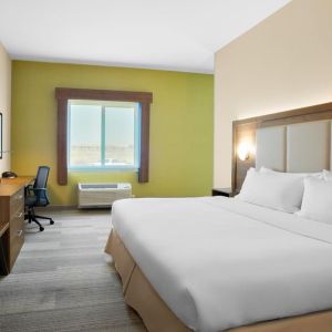 Comfortable king bedroom with TV and business desk at Holiday Inn Express & Suites Ontario.