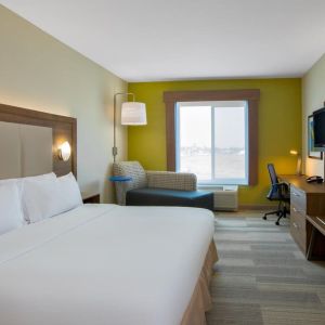 Spacious delux king room with TV and work desk at Holiday Inn Express & Suites Ontario.