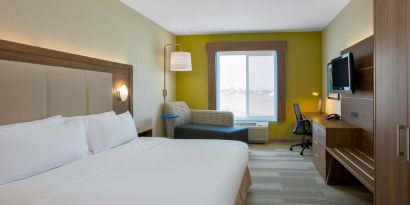 Spacious delux king room with TV and work desk at Holiday Inn Express & Suites Ontario.