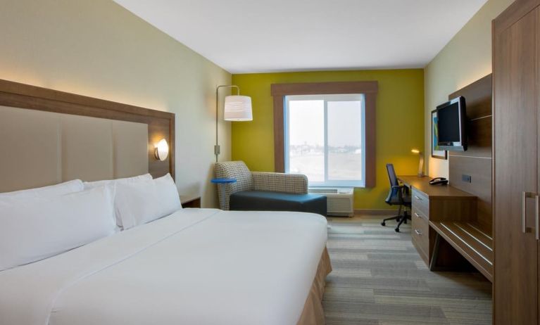 Spacious delux king room with TV and work desk at Holiday Inn Express & Suites Ontario.