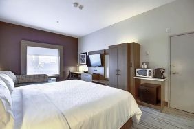 Spacious delux king room with TV and work desk at Holiday Inn Express & Suites Airport-Calgary.