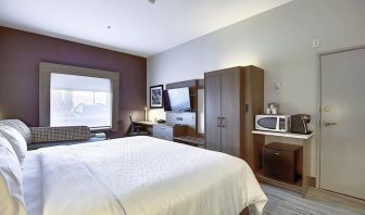 Spacious delux king room with TV and work desk at Holiday Inn Express & Suites Airport-Calgary.