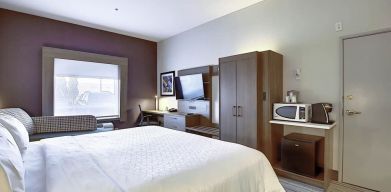 Spacious delux king room with TV and work desk at Holiday Inn Express & Suites Airport-Calgary.