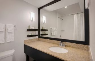 Private guest bathroom with shower at Delta Hotels Orlando Celebration.