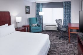 Spacious king suite with TV and business desk at Hilton Garden Inn Dallas/Allen.