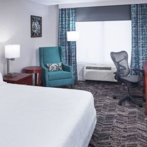 Spacious king suite with TV and business desk at Hilton Garden Inn Dallas/Allen.