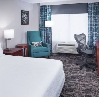 Spacious king suite with TV and business desk at Hilton Garden Inn Dallas/Allen.