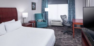 Spacious king suite with TV and business desk at Hilton Garden Inn Dallas/Allen.