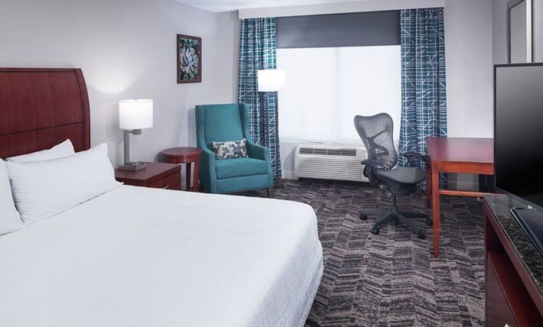 Spacious king suite with TV and business desk at Hilton Garden Inn Dallas/Allen.