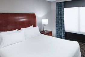 Comfortable king bedroom with natural light at Hilton Garden Inn Dallas/Allen.